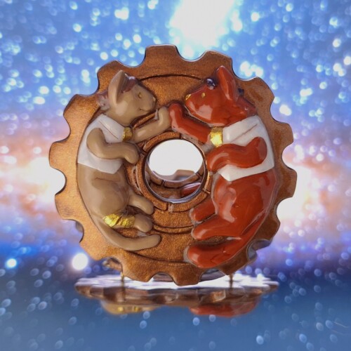 Jayvik Wedding Guest Book A clay sculpture of a gold cog wheel and Jayce and Viktor as cute cats touching paws above the hole in the cog.